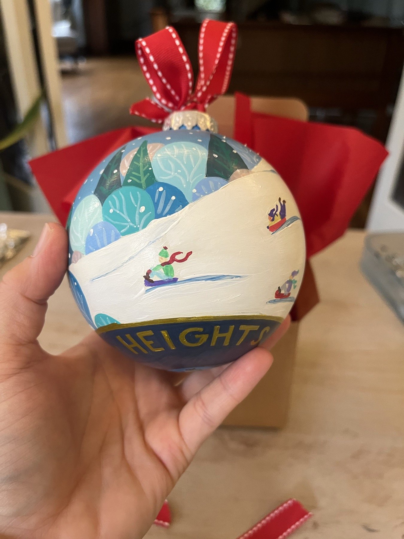 Hand-painted Cleveland Heights ornament showing a snowy hill