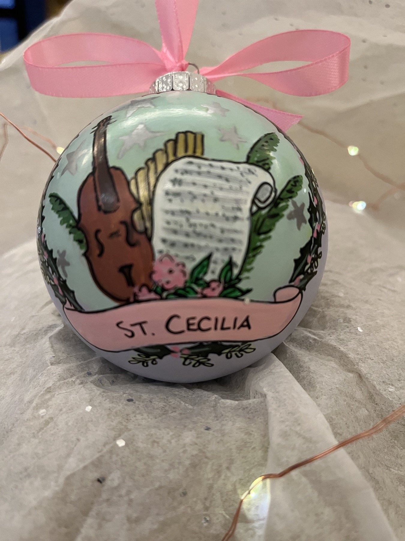 Reverse of a St. Cecilia ornament painted with music and a string instrument