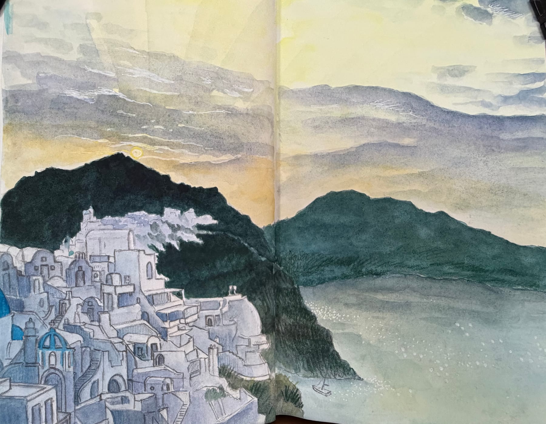 A watercolor sketchbook panorama of white buildings and dark mountains in Santorini